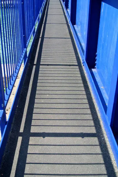Photo of small bridge with blue rail