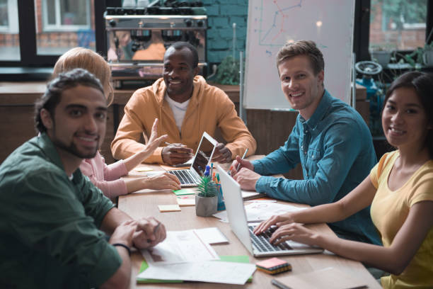 istock Glad business team having job at table 909990760