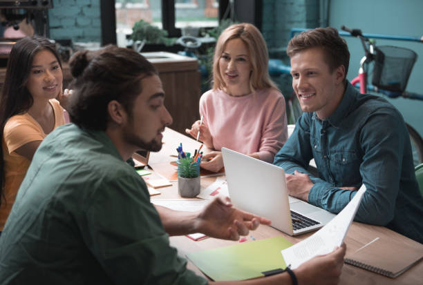 istock Happy colleagues telling with each other 909991010