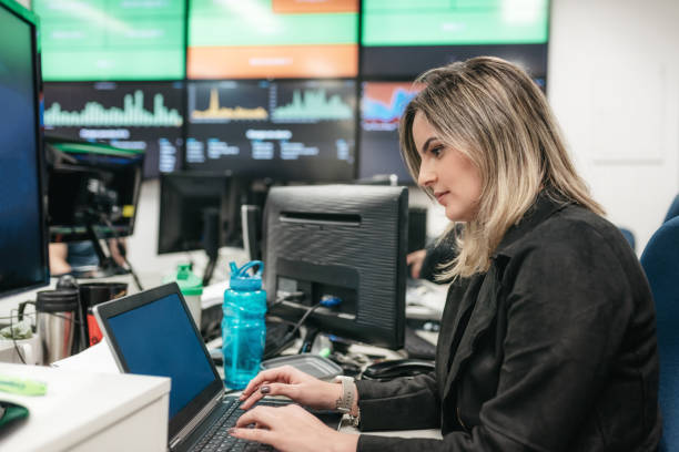 istock young brazilian woman working at computer in big office 909991104