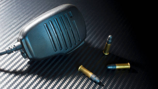 istock Three rimfire cartridges with a police microphone 909997564
