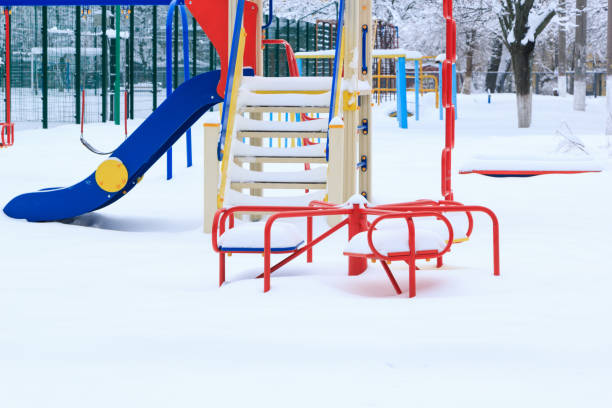 istock Children's playground is covered with snow. 909997960