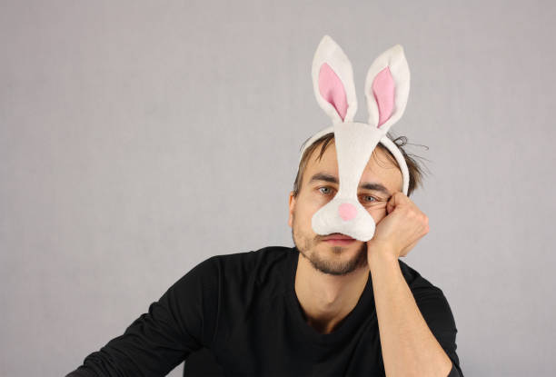 istock man in the mask Easter rabbit and black underwear looking at cam 909998852
