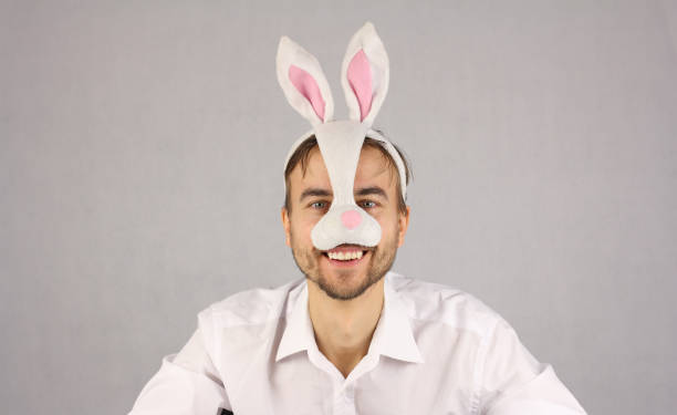 istock man in the mask Easter rabbit looking at camera and smile 910001216