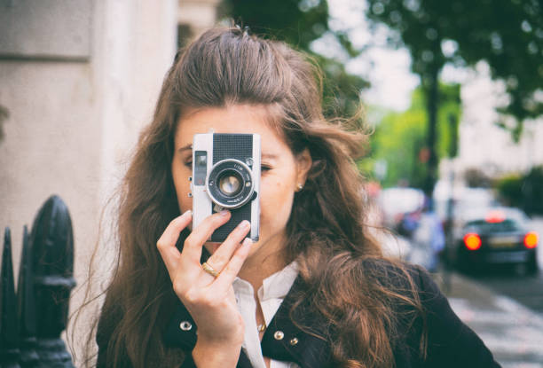 istock Young Woman With A Vintage Camera 910009022