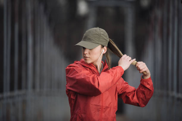 Let's exercise Young strong woman tying her hair in ponytail and getting ready for practice woman tying hair in ponytail getting ready for exercising stock pictures, royalty-free photos & images