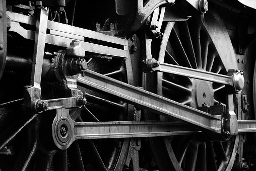 Group of red wheels and steel machinery of antique steam locomotive