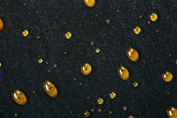 istock Abstract black background with golden glitter dots. Caramel on frying pan 910016182