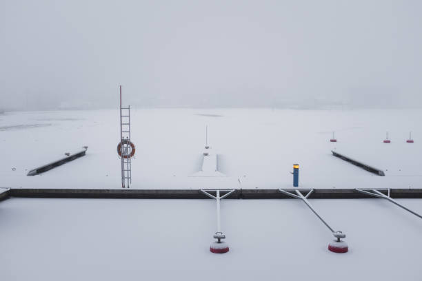 Winter view of empty marina with with a strong fog
