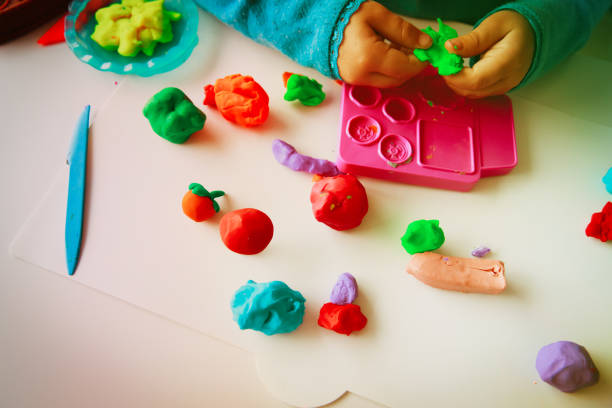 istock Child playing with clay molding shapes 910024788