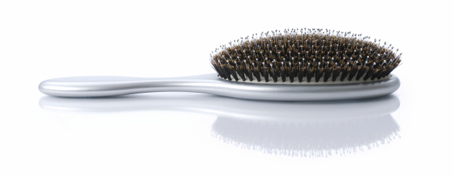 Silver hairbrush with reflection. 