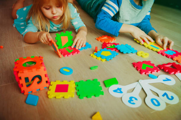 istock kids learning numbers, calculations, play with puzzle 910029988