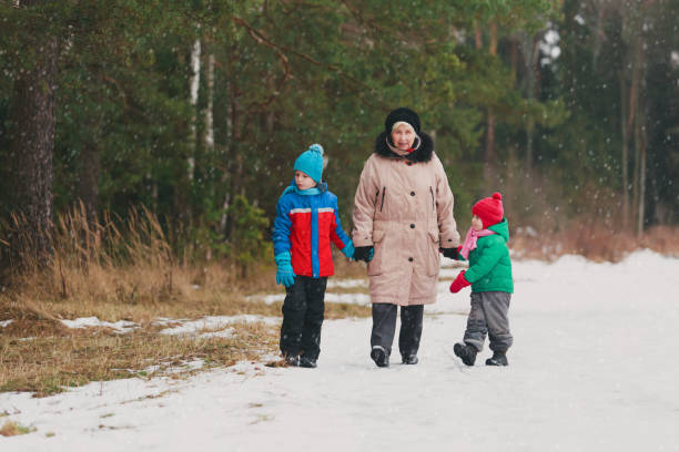 istock grandmother with kids walk in nature 910030392