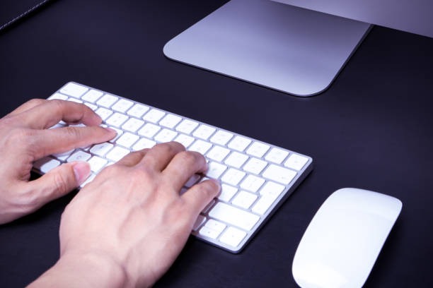 istock focus on the men hand on the white keyboard and mouse 910030830
