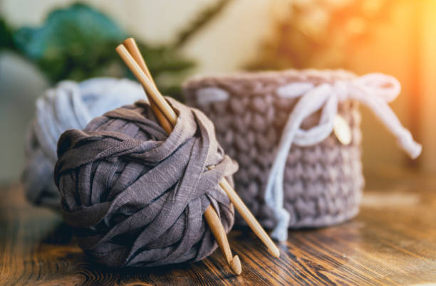 istock Knitted baskets on a wooden table. Handmade. 910041740