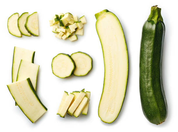 Fresh whole and sliced zucchini Fresh whole and sliced zucchini isolated on white background. From top view halved photos stock pictures, royalty-free photos & images