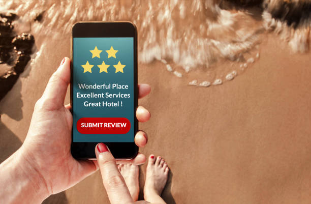 istock Customer Experience Concept, Woman using Smart Phone on Summer Beach to Review and Feedback Five Star Rating for Hotel in Online Satisfaction Survey, Top View 910043652
