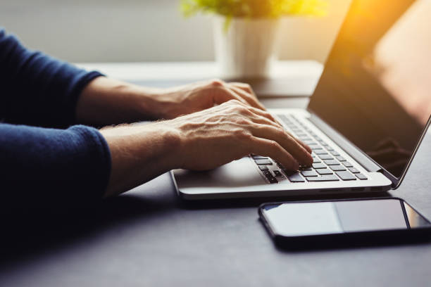 istock Man typing on laptop in the office 910052134