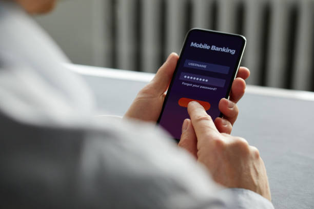 istock Man signs up for banking with his cell phone 910052554