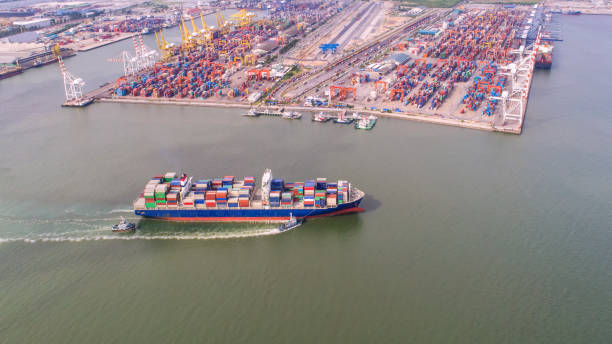 istock container,container ship in import export and business logistic,By crane,Trade Port , Shipping,cargo to harbor.Aerial view,Water transport,International,Shell Marine,transportation,logistic,trade,port 910056994
