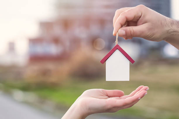 istock Small toy house in hand 910057054