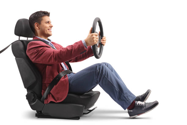 istock Elegantly dressed guy sitting in a car seat and driving 910058136