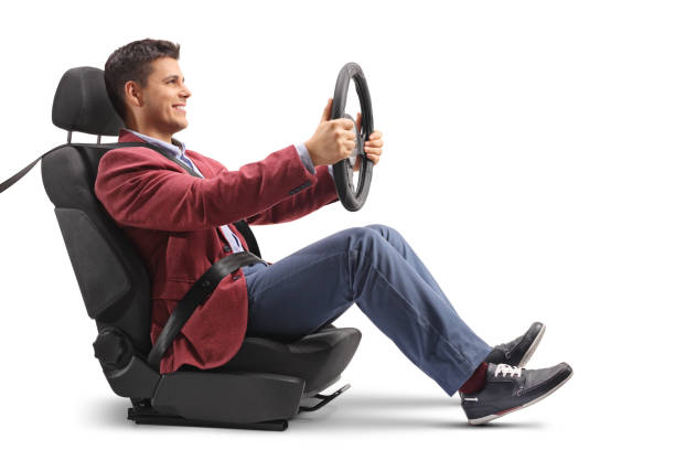 Elegantly dressed guy sitting in a car seat and driving Elegantly dressed guy sitting in a car seat and driving isolated on white background driving steering wheel stock pictures, royalty-free photos & images