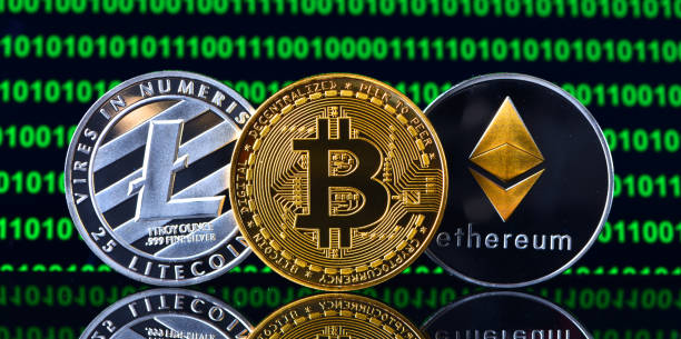 Crypto currency coins İstanbul, Turkey - January 24, 2018: Close up shot of memorial coins of bitcoin, litecoin and ethereum on a screen displaying binary code . Bitcoin, Litecoin and Ethereum are  crypto currencies and a worldwide payment systems.ethere litecoin stock pictures, royalty-free photos & images