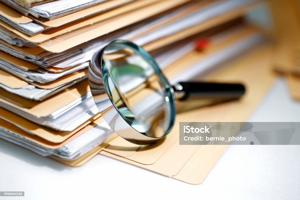 Documents Search Magnifying glass Search Documents ; shot with very shallow depth of field Exploration Stock Photo
