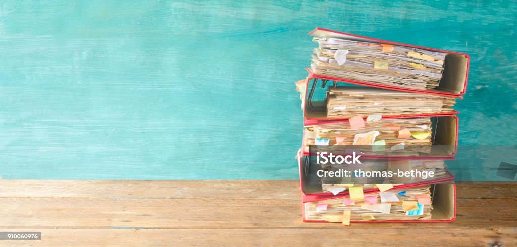 stack of messy file folders and documents,red tape concept,free copy space Bureaucracy Stock Photo