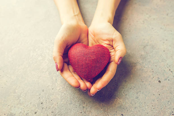 istock Female hands giving red heart 910061080