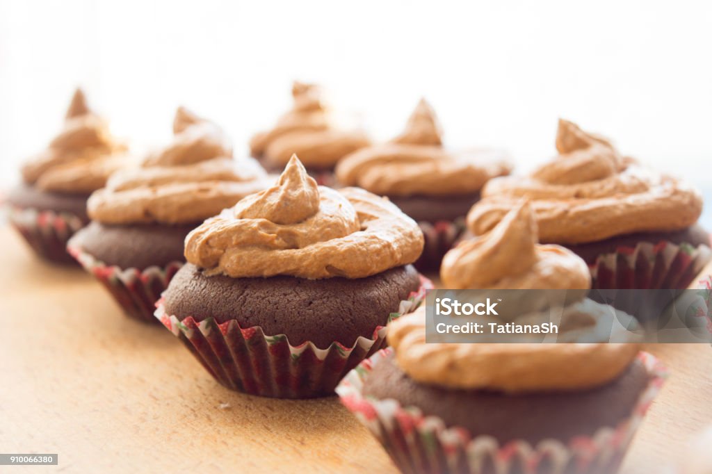Beautiful background with chocolate cupcakes. Cupcakes with cream. Sweet dessert. Backgrounds Stock Photo