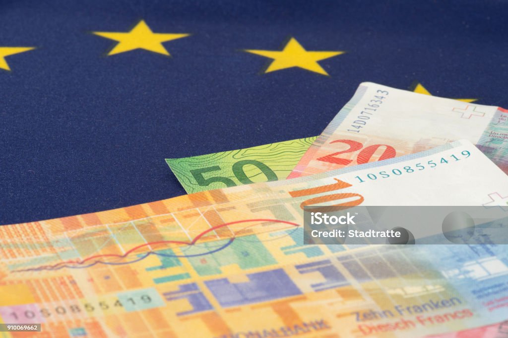 Flag of the European Union EU and Swiss Franc banknotes Flag of the European Union EU and Swiss franc banknotes Barricade Stock Photo