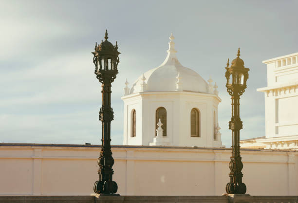 Old historic pier and lanterns on the La Caleta beach (Antiguo Balneario de la Palma). Cadiz, Andalusia, Spain