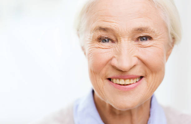 istock happy senior woman face at home 910069968