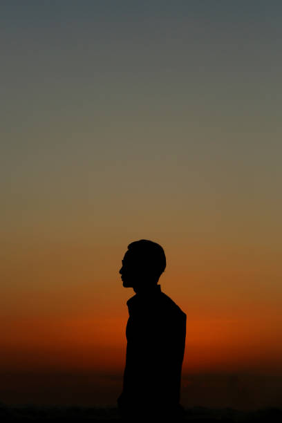 istock Silhouette of man at sunset 910073110