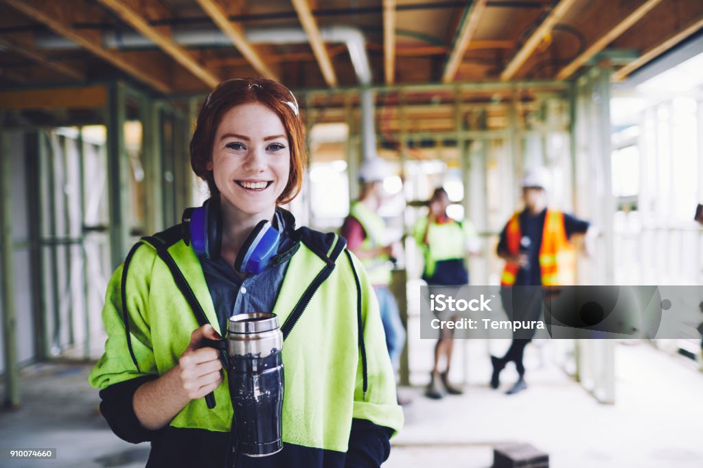 Construction workers in Australian in building site working and doing tasks. SydneyConstruction Construction Worker Stock Photo
