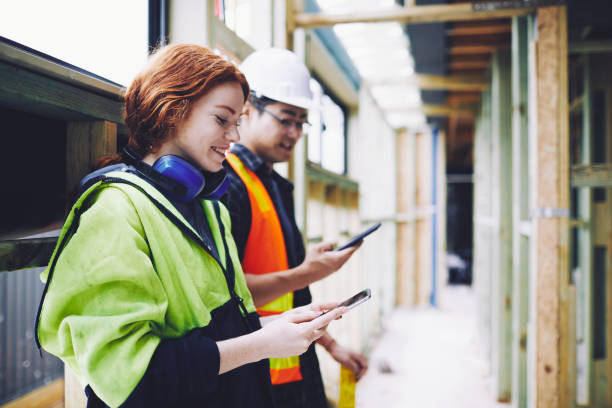 construction workers in australian in building site working and doing tasks. - female construction telephone building contractor imagens e fotografias de stock