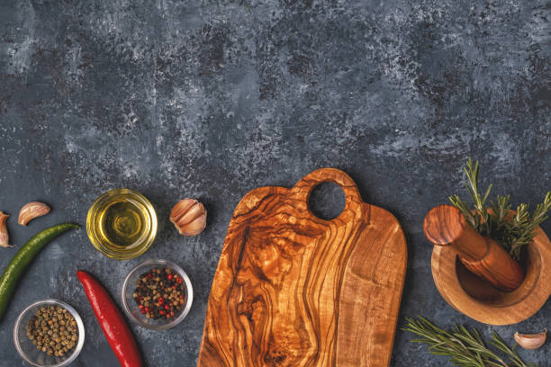 istock Cutting board and spice for cooking on a dark background. 910081224