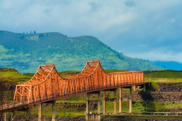The Dalles Bridge seen and photographed from car traveling on I-84 through the Columbia River Gorge in Oregon.  Washington State is on the other end of the bridge that crosses the Columbia River