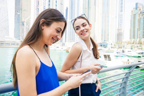 istock Two friends meeting in Dubai Marina downtown 910085106