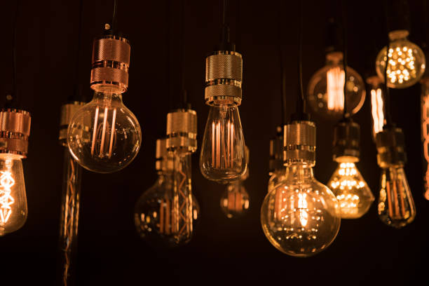 istock Illuminated Lighting Equipment Hanging In Darkroom 910091404