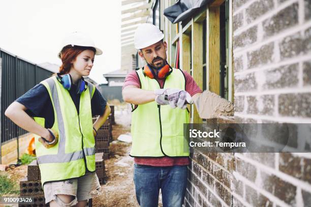 Construction Workers In Australian In Building Site Working And Doing Tasks Stock Photo - Download Image Now