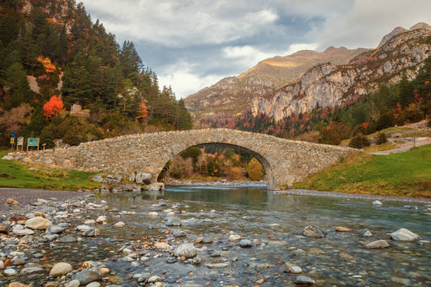 Romanesque bridge in the valley of Bujaruelo, XIII century on the Ara river, in the Aragonese Pyrenees, Huesca, Spain stock photo