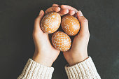 Hands holding handpainted easter eggs