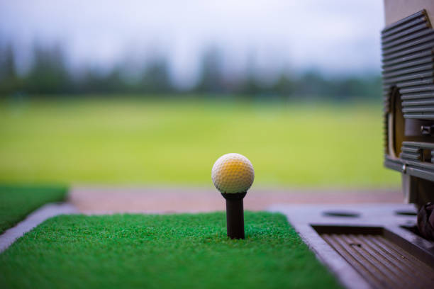 istock The golf ball on tee at driving range. Golf Driving Range with Golf Mat 910103938