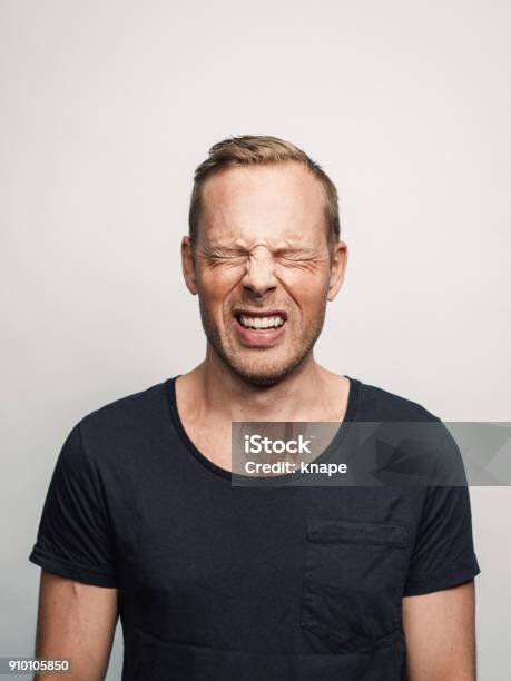 Mid Adult Man With Expression Feelings On His Face Studio Shot Series In Pain Eyes Closed Stock Photo - Download Image Now