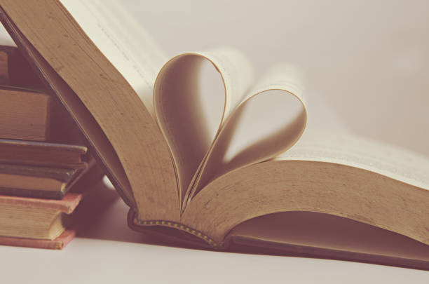 istock Heart Shape Formed By Book Pages On Table 910111338