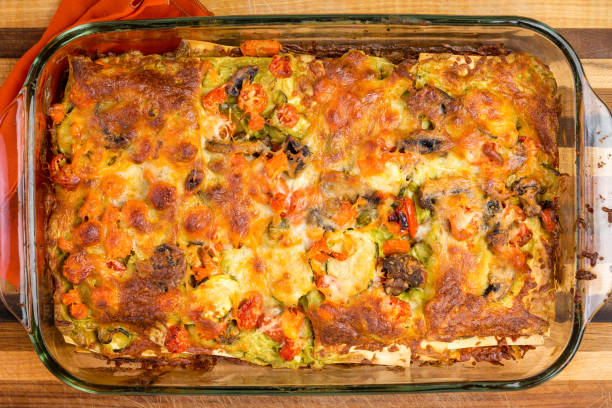 Freshly oven baked homemade vegetable lasagne with cheese in a glass oven dish viewed close up from above