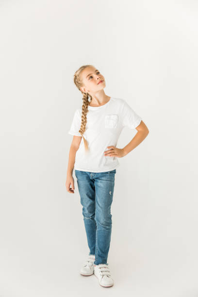 child standing with hand on hip and looking up isolated